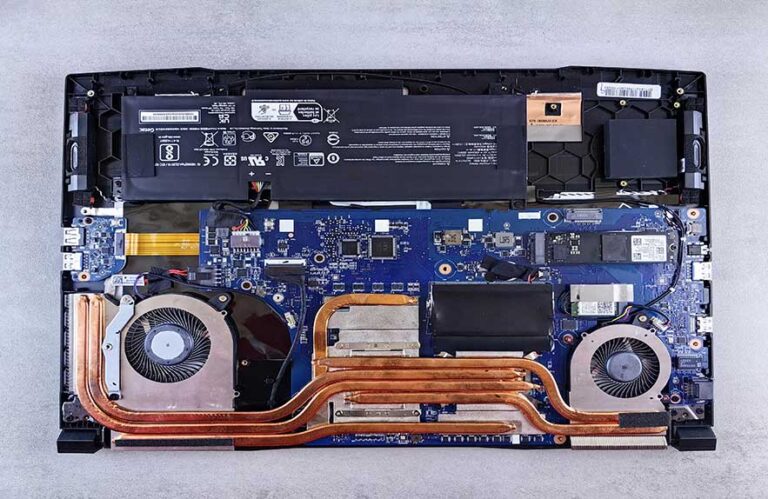 internal parts of a desktop computer showing fans, heat pipes, and motherboard layout
